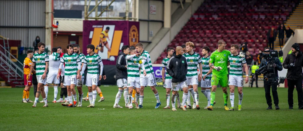 Celtic players celebrate with Brendan Rodgers after winning 3-1 at Motherwell.